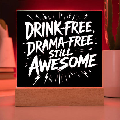 LED plaque with black panel and white slogan DRINK-FREE, DRAMA-FREE, STILL AWESOME, red-lit frame