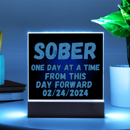 SOBER LED square plaque with bright blue glow border, blue text, and dark base