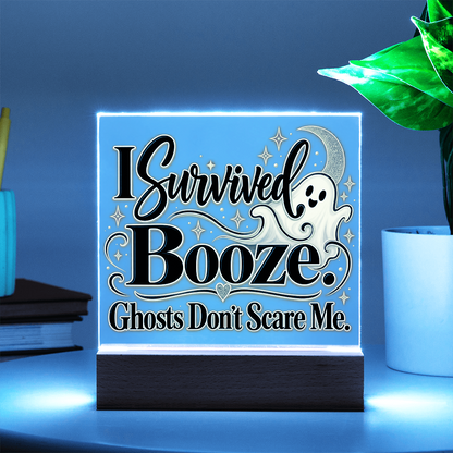 LED-lit acrylic Halloween plaque on wood base, ghost and “I Survived Booze” text glowing blue