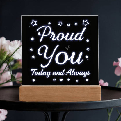 LED message plaque reading “Proud of You” and “Today and Always” with glowing white text