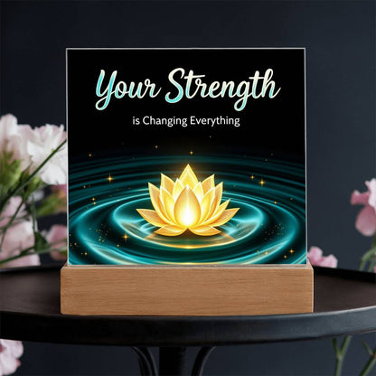 LED strength plaque with “Your Strength” text and glowing lotus in water ring, on wood base
