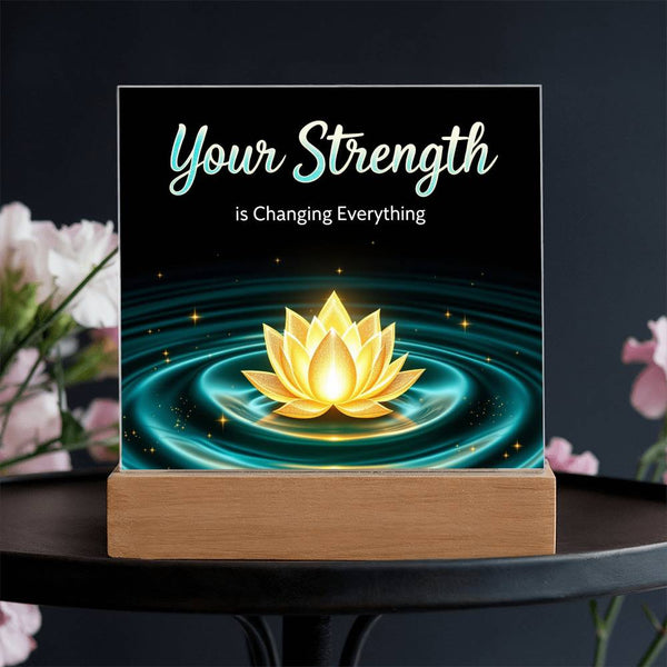 LED strength plaque with “Your Strength” text and glowing lotus in water ring, on wood base