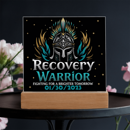 Square acrylic LED plaque on wood base, black front with teal title, white-lit frame border