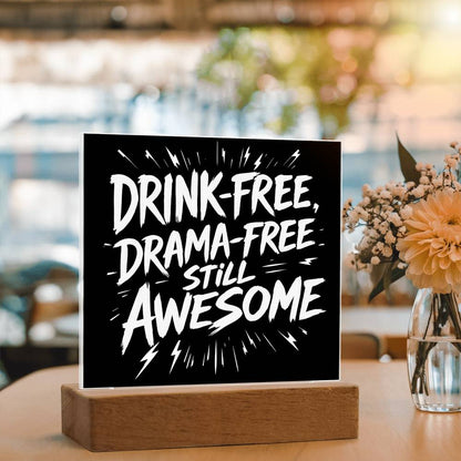 LED plaque with black panel and white slogan DRINK-FREE, DRAMA-FREE, STILL AWESOME on wood base