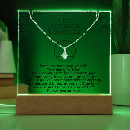 LED acrylic plaque with necklace, green glowing border and heart pendant on chain