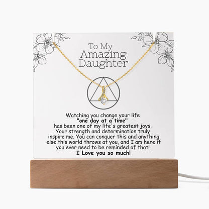 LED acrylic plaque with necklace and heart pendant on gold-toned chain, wood base