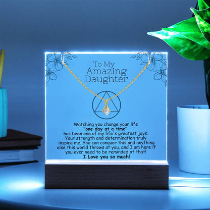 LED acrylic plaque with necklace and heart pendant on gold-toned chain, blue-lit frame