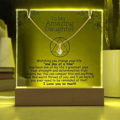 LED acrylic plaque with necklace and heart pendant on gold-toned chain, warm yellow light