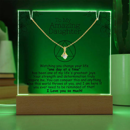 LED acrylic plaque with necklace and heart pendant on gold-toned chain, green-lit frame