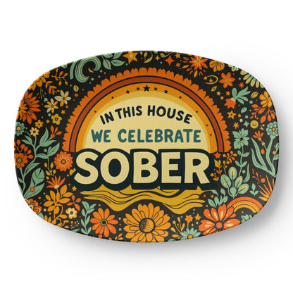 Decorative oval platter with “IN THIS HOUSE WE CELEBRATE SOBER” floral artwork