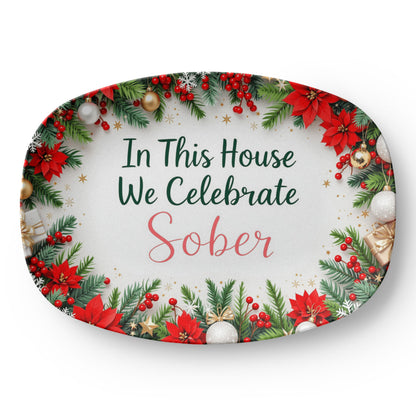 Oval serving platter with poinsettia wreath border and 'In This House We Celebrate Sober' text
