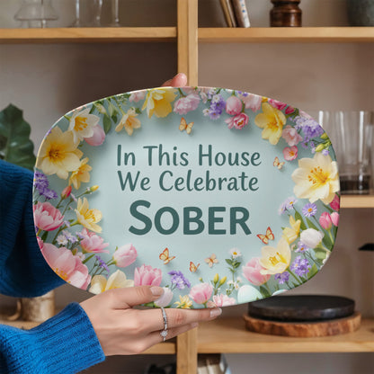 Serving platter held by hand, floral border and teal center text: “In This House We Celebrate SOBER”