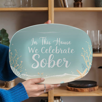 Seafoam oval platter held in hand with message “In This House We Celebrate Sober”