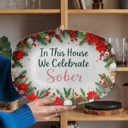 Oval serving platter held in hands, poinsettia wreath border with 'In This House We Celebrate Sober'