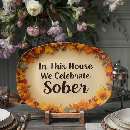 Oval serving platter with autumn leaf border and text "In This House We Celebrate Sober"