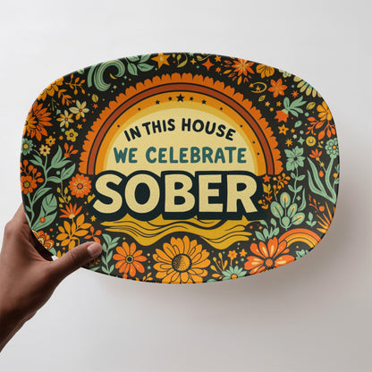 Decorative oval platter with bold “SOBER” text and green floral details