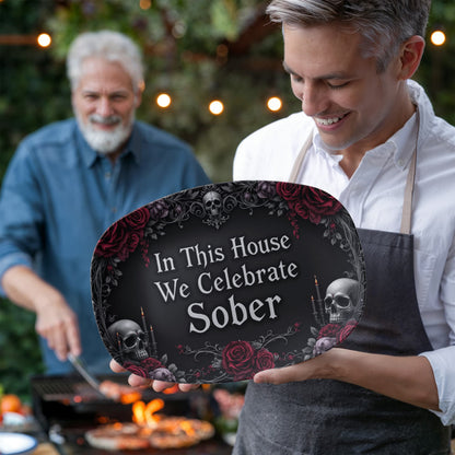 Oval serving platter with gothic quote, skulls, and red roses; held by a cook