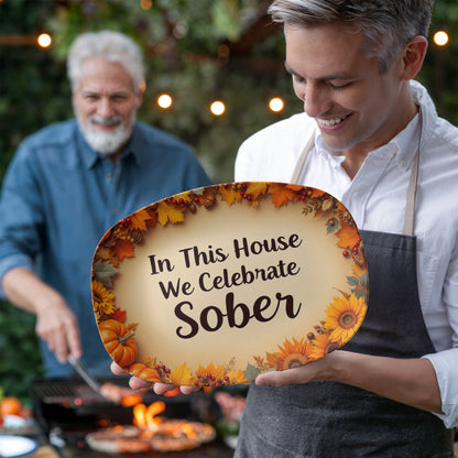 Oval serving platter with autumn leaf border and text "In This House We Celebrate Sober"