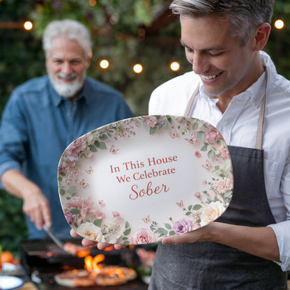 Oval serving platter with pink and green floral border, 'In This House We Celebrate Sober' text