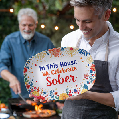 Oval serving platter showing “In This House We Celebrate Sober” with fireworks and flowers