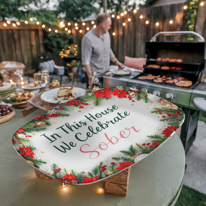 Oval serving platter with poinsettia wreath border and 'In This House We Celebrate Sober' wording
