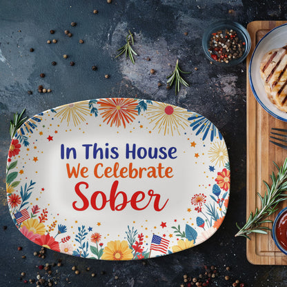 Oval platter displaying “In This House We Celebrate Sober” with fireworks and floral accents