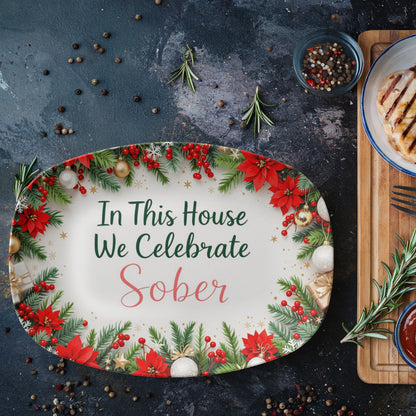 Oval serving platter with poinsettia wreath border and 'In This House We Celebrate Sober' text