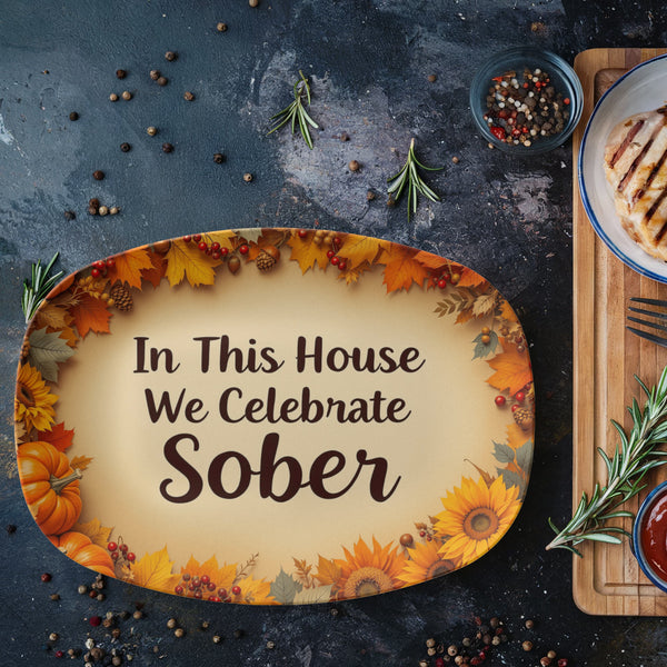 Oval serving platter with autumn leaf border and text "In This House We Celebrate Sober"