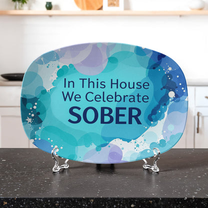 Oval serving platter on metal easel, blue abstract design with 'In This House We Celebrate SOBER'.