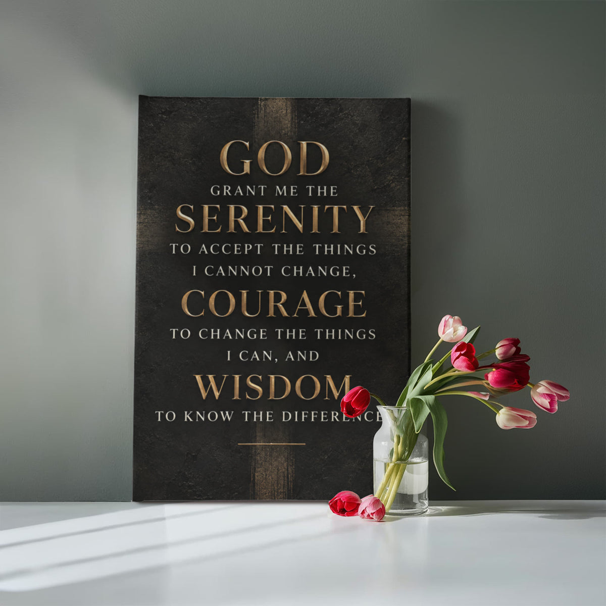 Black vertical canvas wall art with gold Serenity Prayer text against dark wall.