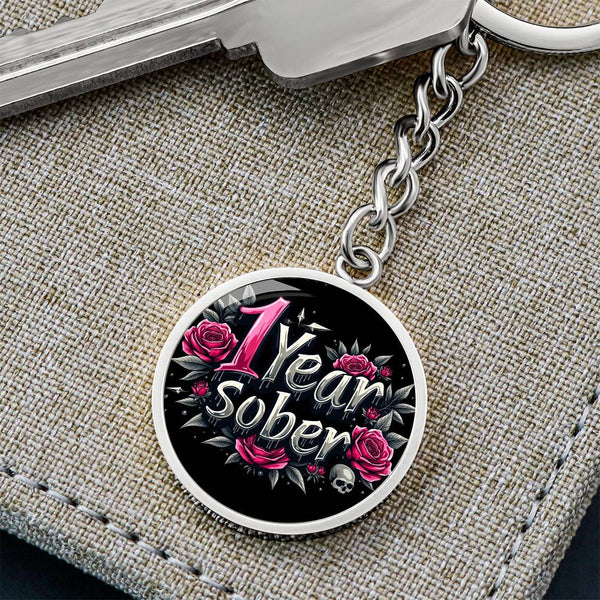 Silver keychain with round “1 Year Sober” medallion, roses, and linked chain