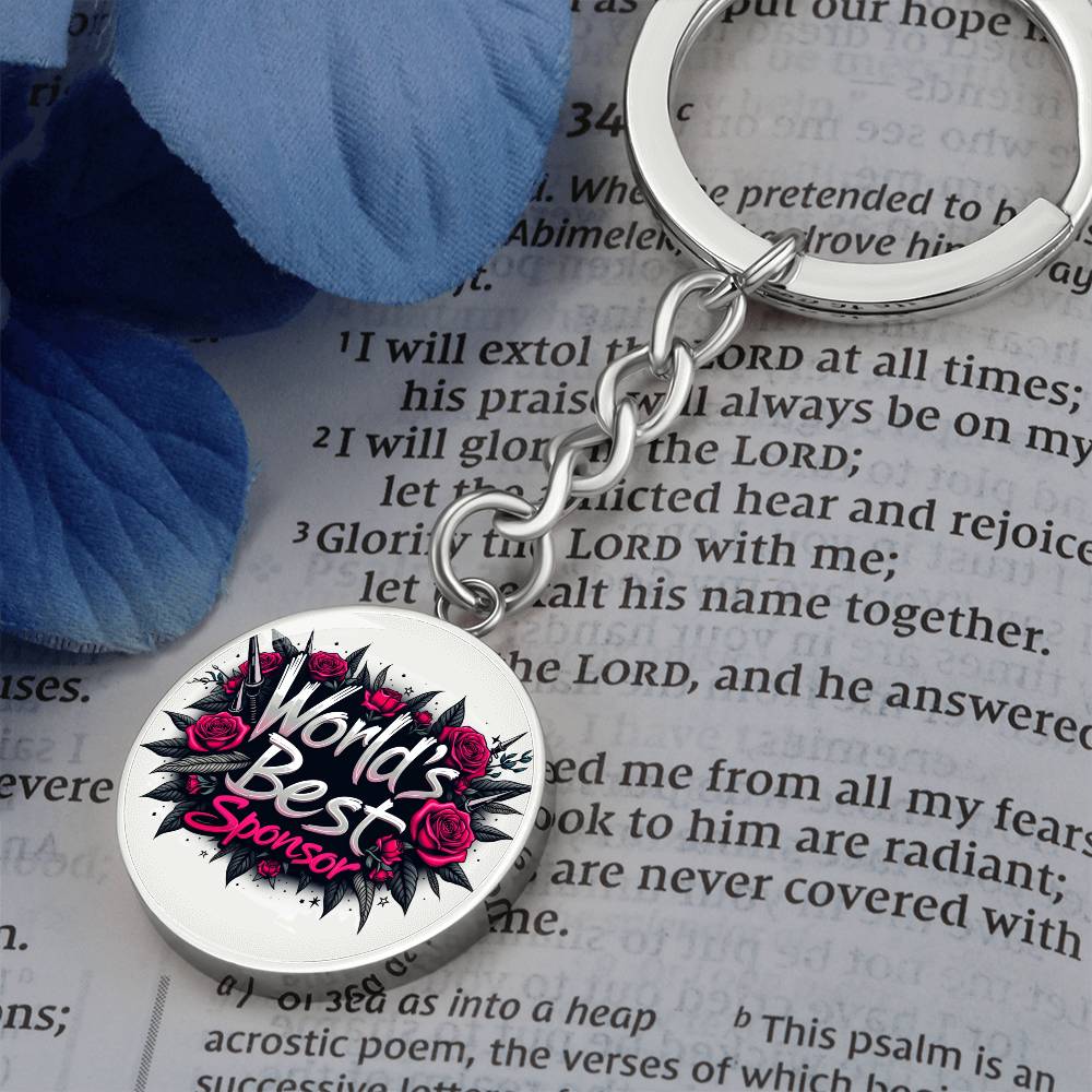 Round silver keychain with rose graphic and “World’s Best Sponsor” text
