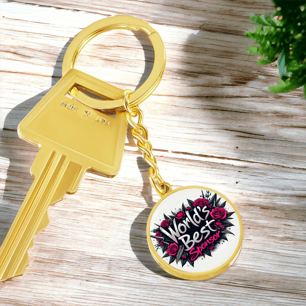 Gold keychain with keyring and round charm showing rose “World’s Best Sponsor” logo