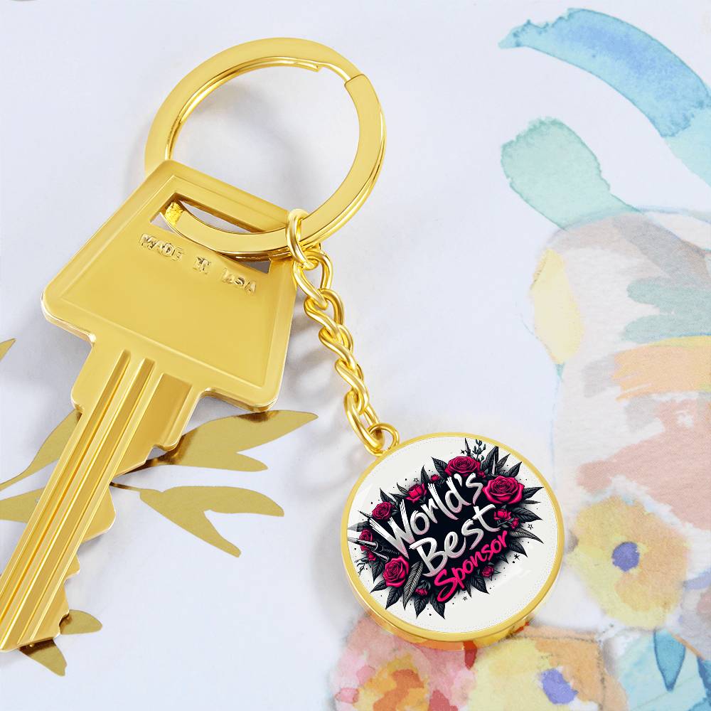 Gold keychain with heart-shaped keyring tag showing rose “World’s Best Sponsor” logo
