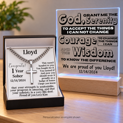 Gift set featuring a Cuban link cross necklace beside a glowing personalized LED plaque