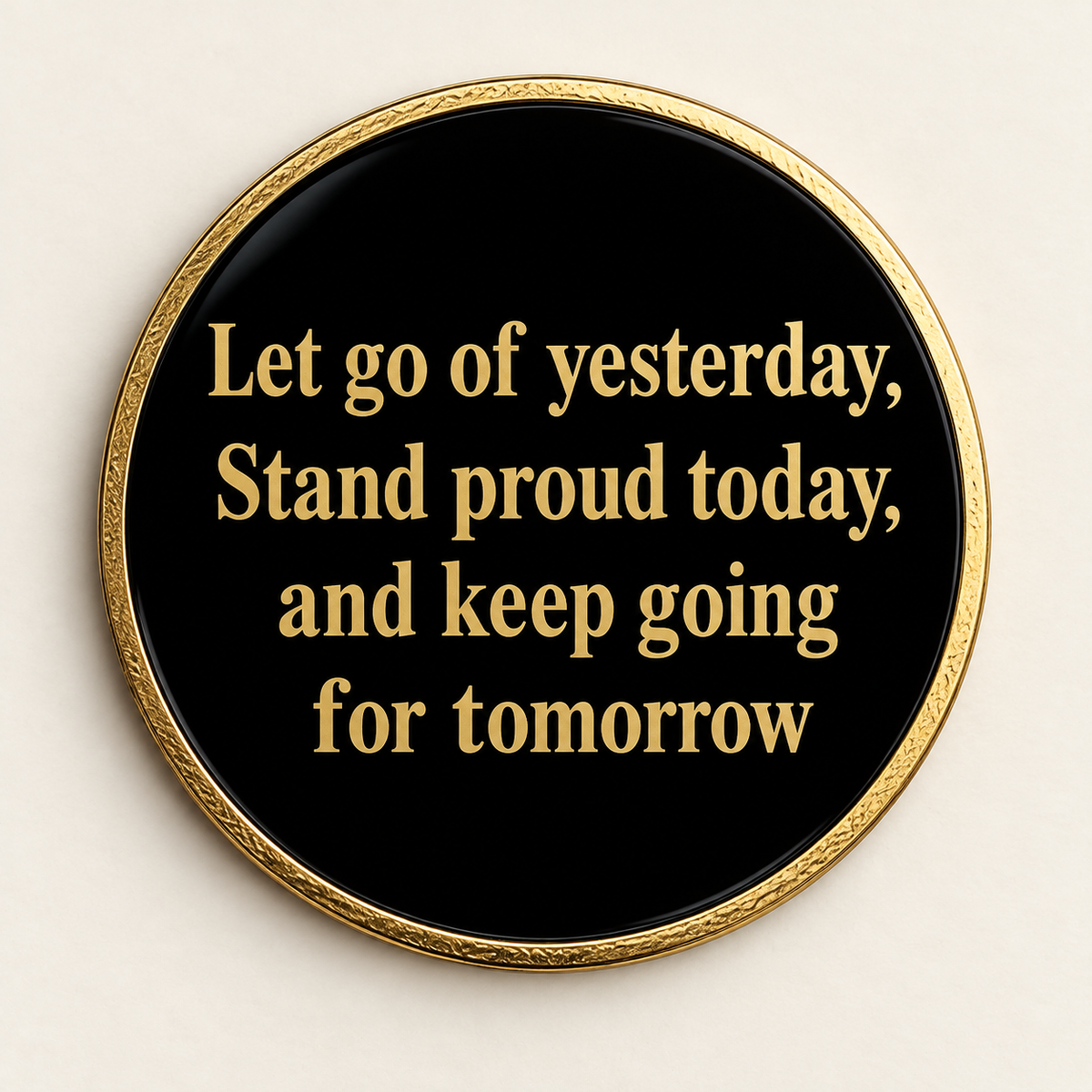 Black recovery coin back with gold rim and message about letting go and moving forward