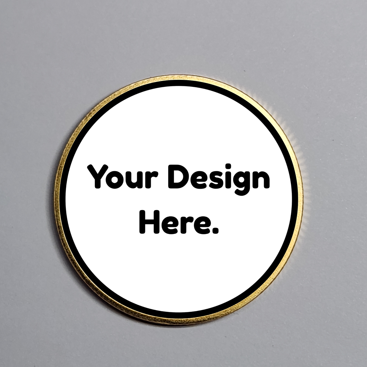 Round gold custom coin with placeholder text "Your Design Here."