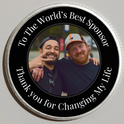 Round black photo coin with silver rim; two men in a portrait with sponsor lettering.