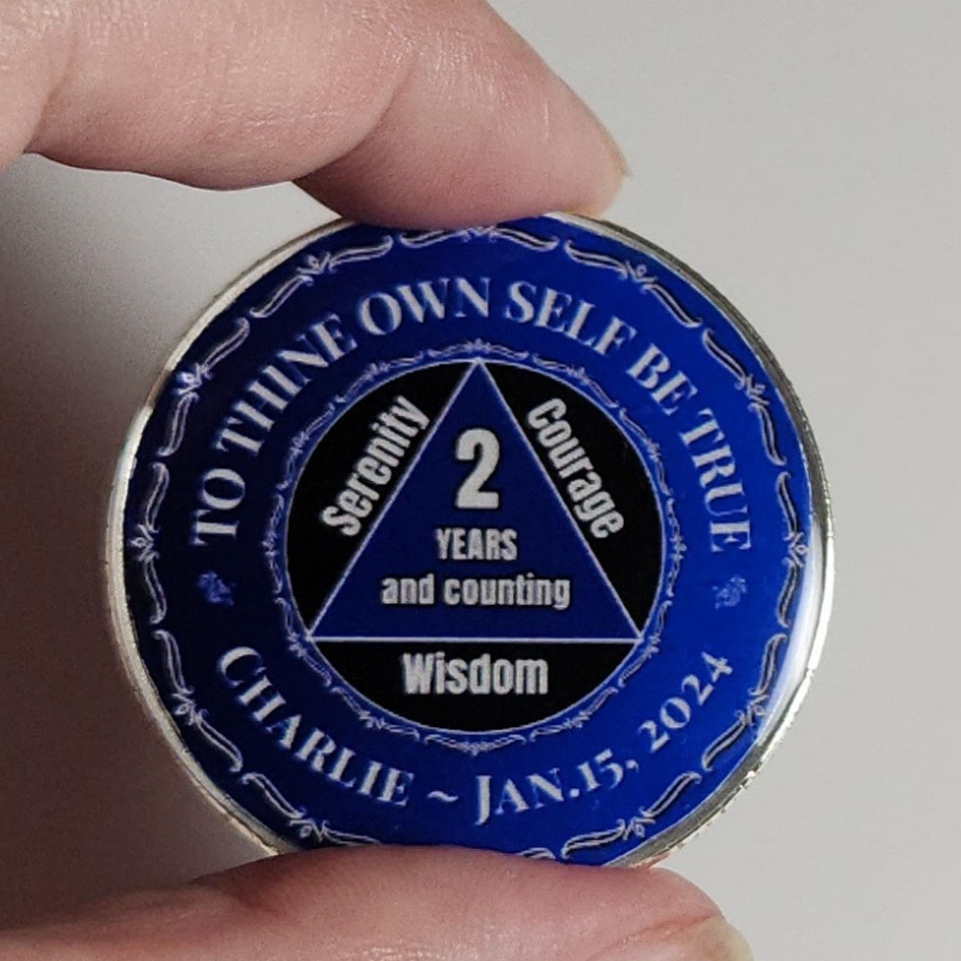 Blue personalized coin with '2 years and counting' and Charlie - Jan. 15, 2024