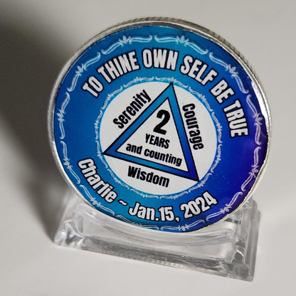 Blue personalized coin on clear stand: '2 years and counting' and Charlie - Jan. 15, 2024