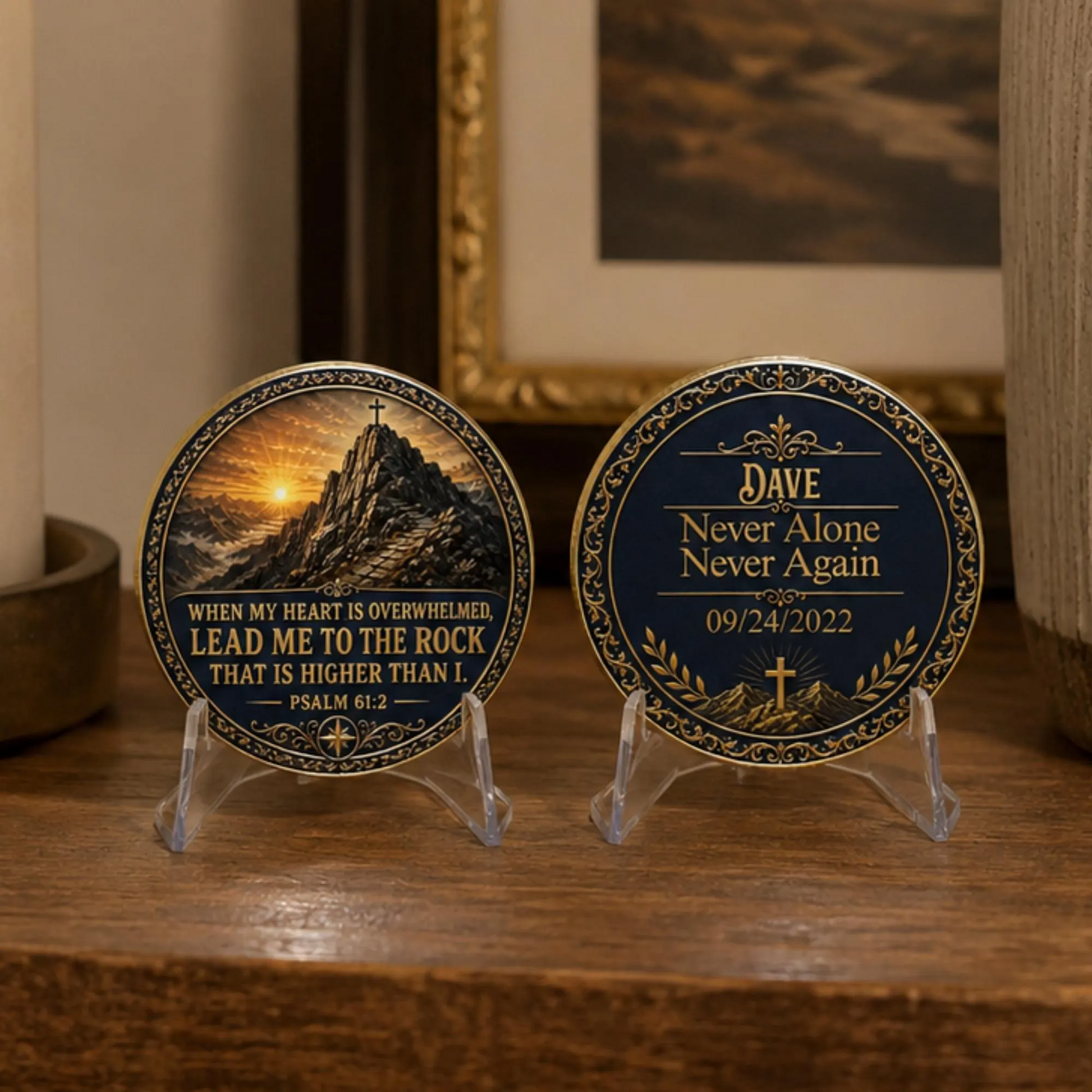 Two gold-toned medallion coins on clear acrylic stands on a wooden table