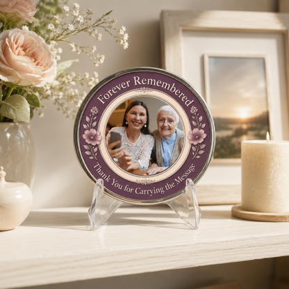 Round memorial sponsor coin with two-photo portrait and purple floral border on clear stand