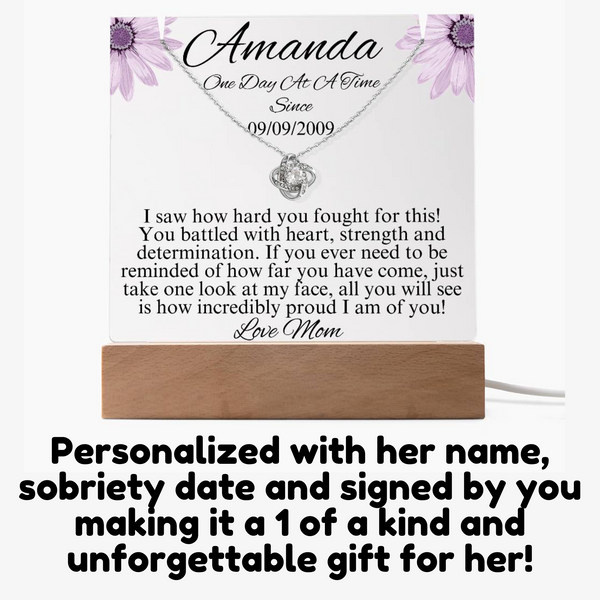 LED sobriety gift set with necklace and message card on a wooden base