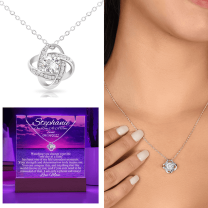 Silver-tone heart pendant necklace with cubic zirconia stones, shown on neckline