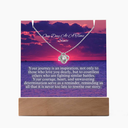 LED necklace gift set with silver-tone heart pendant, quote card, and wooden base