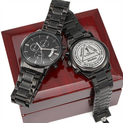 Black recovery watch and engraved token on red gift box lid
