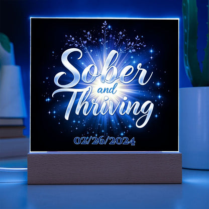 LED acrylic plaque: 'Sober and Thriving' with date on wood base, blue glowing border