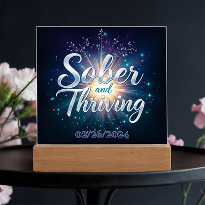 LED acrylic plaque with 'Sober and Thriving' and date on wood base, front view