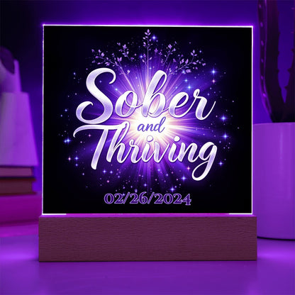 LED acrylic plaque: 'Sober and Thriving' with date on wood base, glowing border