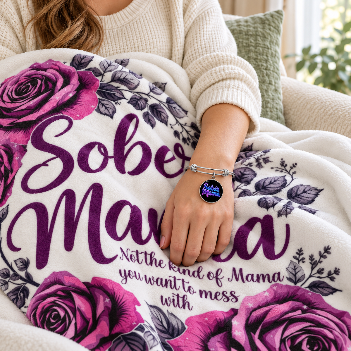Floral blanket with magenta roses and lettering, shown with matching silver charm bracelet